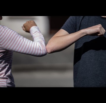 Elbow bump, a creative way to greet people during the COVID-19 pandemic. Credit: noahmatteo on Unsplash  