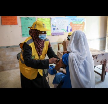 Shagufta, a (LHW) Lady Health Worker administers a measles and rubella injection to an adolescent girl during the nationwide MP campaign in PIB Government Girls Secondary School, Karachi, Sindh province, Pakistan. Credit: Gavi/2021/Asad Zaidi