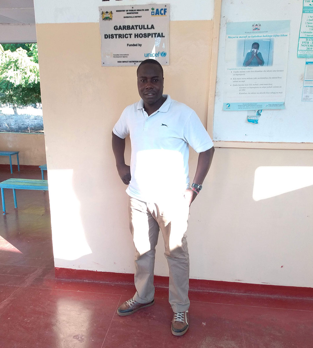 Health worker Alex Ochola stands outside the Garbatulla county hospital.