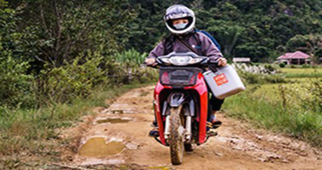 Transportation of oral cholera vaccines on a muddy road in Sekong Province, Laos.