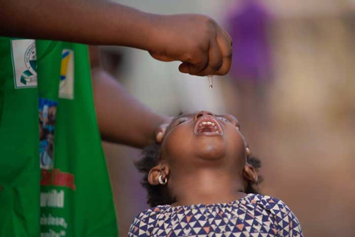 The lifesaving drop of the oral polio vaccine being administered to a child during an immuzation campaign  in Maraba, Nassarawa State. Credit: WHO/Ogbeide E.