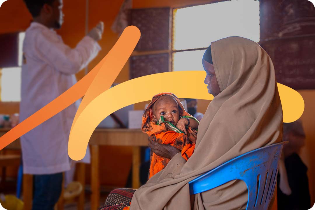 A woman holding her child during a vaccination session. Credit: Gavi