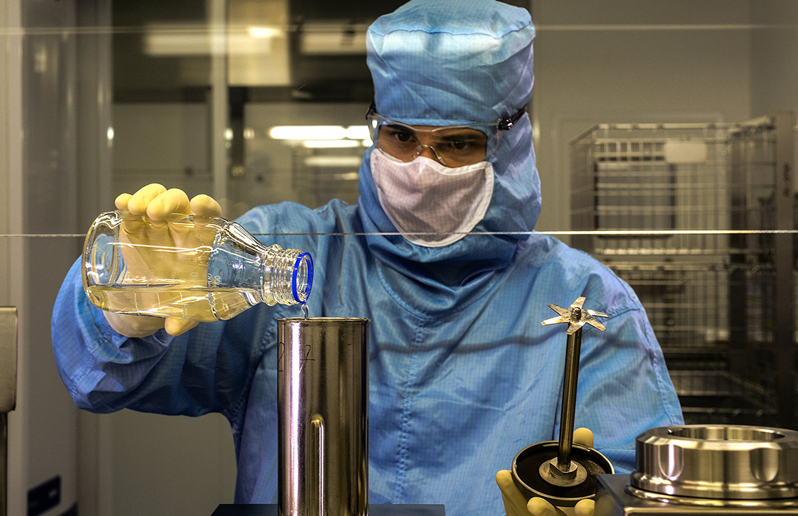 Vaccine lab technician mixing chemicals