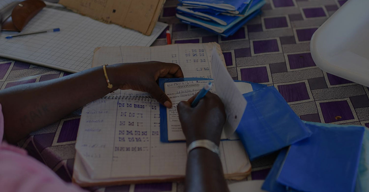 nurse filling out vaccination booklet
