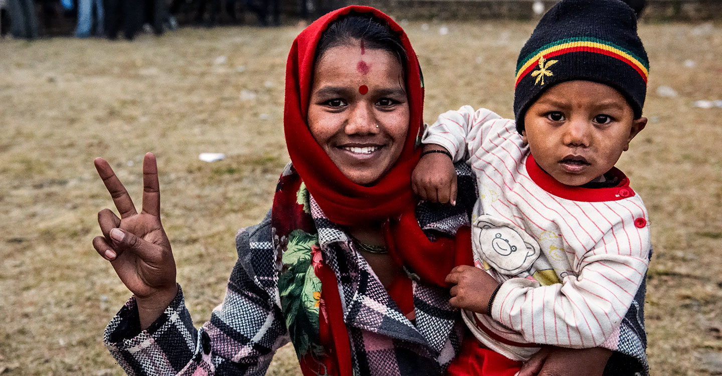 Mother holding baby boy in Nepal