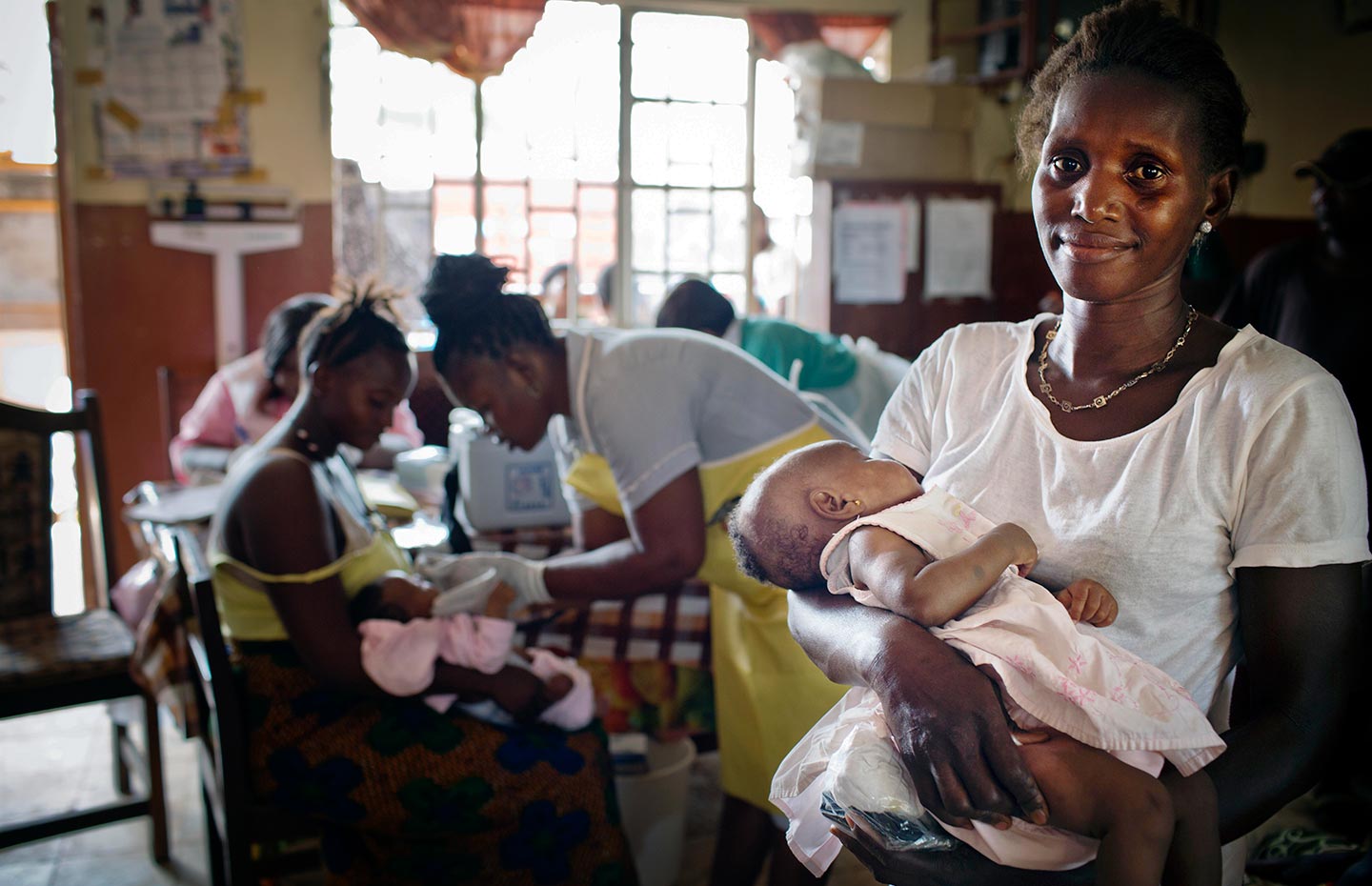 Gavi/2016/Kate Holt/Sierra Leone- A woman waits with her daughter to be vaccinated at a maternal and child health clinic in a health centre in Freetown, Sierra, Leone on 17th February, 2016