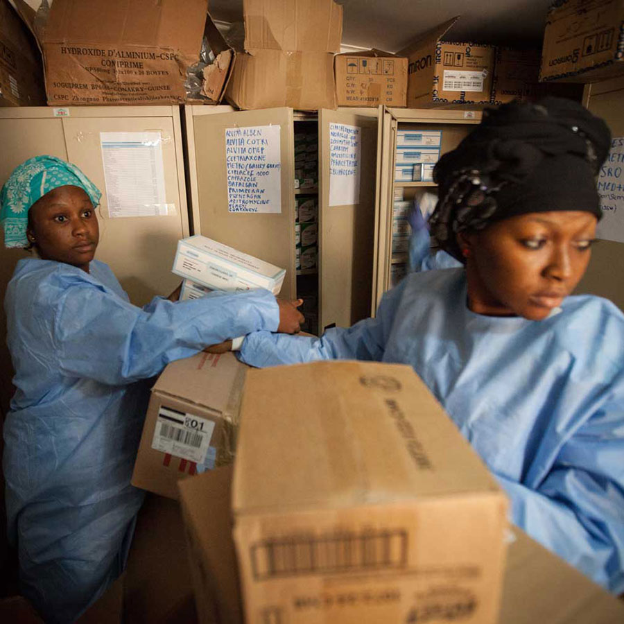 WHO staff prepare pharmaceuticals for the participants in the clinical trials of the Ebola vaccine in Guinea. Photo: WHO/2015/Sean Hawkey