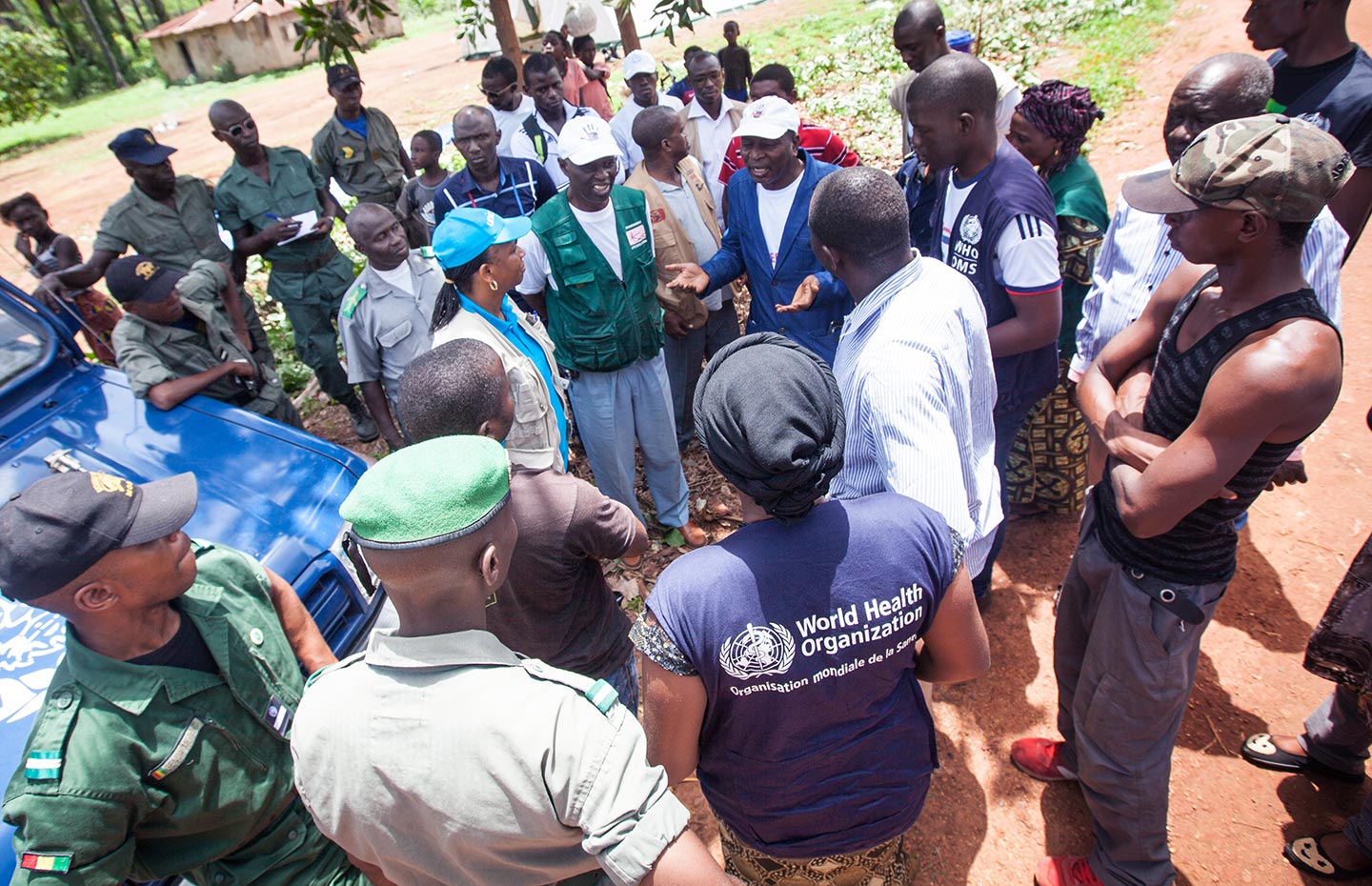 2015/Sean Hawkey/Guinea- Dr. Sakoba Keita, coordinator of the Guinean Ebola Response speaks to people manning a road block that obliges all travellers to wash their hands in a bleach solution and their temperature taken