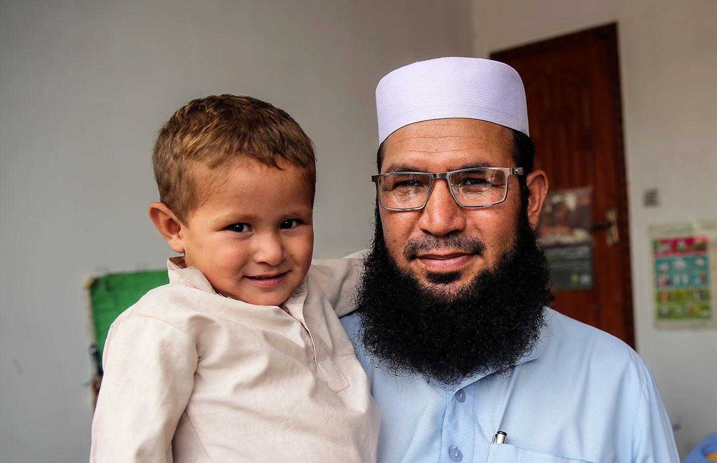 A man with his son during a vaccination session in Punjab Province, Pakistan. Credit: Gavi/2017/Asad Zaidi.