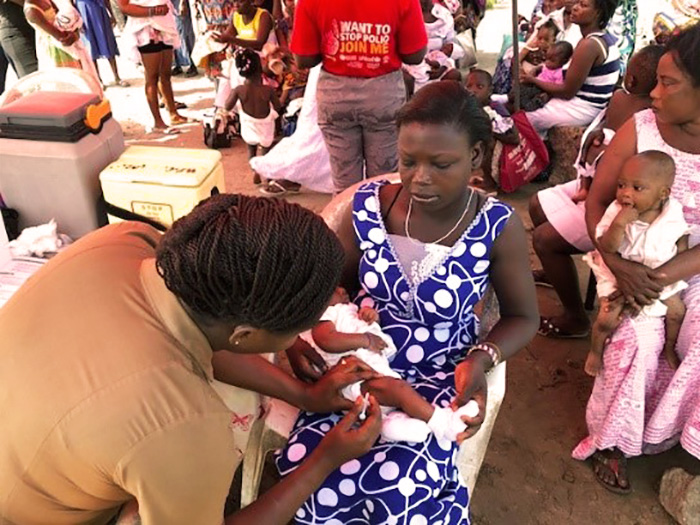 newborn getting getting vaccinated by health worker 