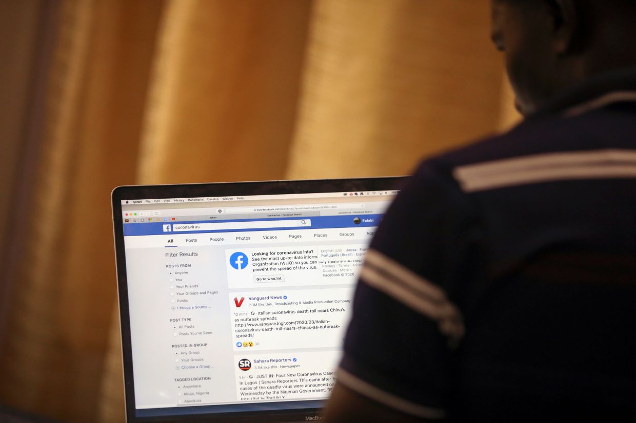 Image from The Star article: A man opens the Facebook page on his computer to fact check coronavirus disease (Covid-19) information, in Abuja, Nigeria. — Reuters Image from The Star article: A man opens the Facebook page on his computer to fact check coronavirus disease (Covid-19) information, in Abuja, Nigeria. — Reuters