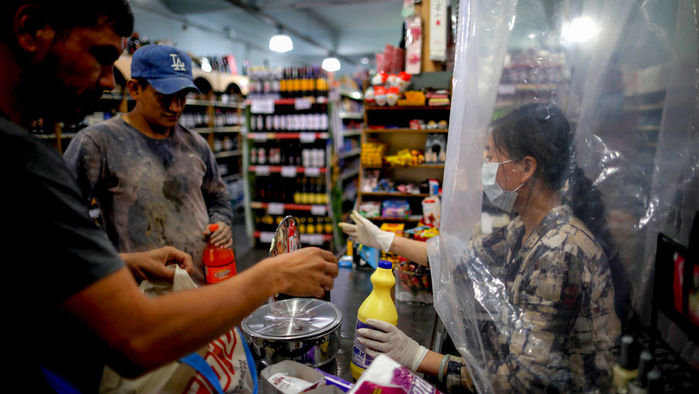 Iamge from sciencemag article: A supermarket cashier in Buenos Aires, Argentina, waits for costumers behind a makeshift plastic curtain as a precaution against the spread of the coronavirus that causes COVID-19. Iamge from sciencemag article: A supermarket cashier in Buenos Aires, Argentina, waits for costumers behind a makeshift plastic curtain as a precaution against the spread of the coronavirus that causes COVID-19.