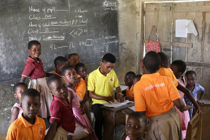 Image from Aljazeera article – Pupils gather around their teacher in class in Prestea, a mining town in southwest Ghana [File:Siphiwe Sibeko/Reuters]