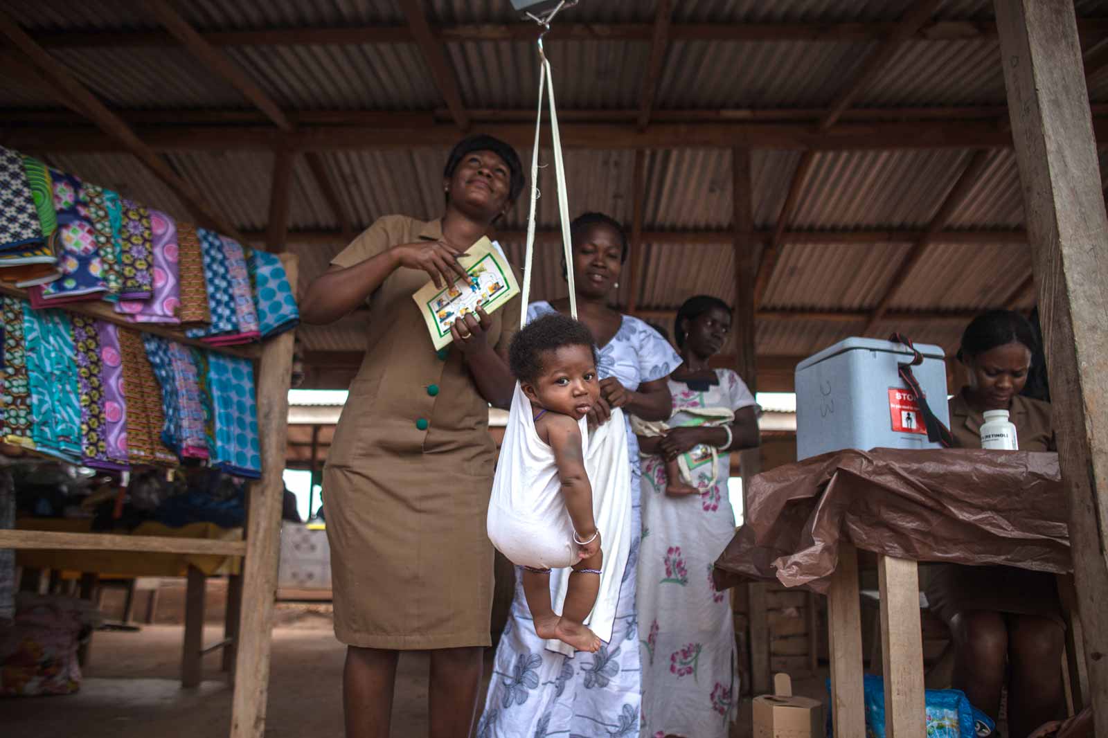 At a busy market in Dodowa, in Dagame West District, an outreach clinic is set up to give vaccines.