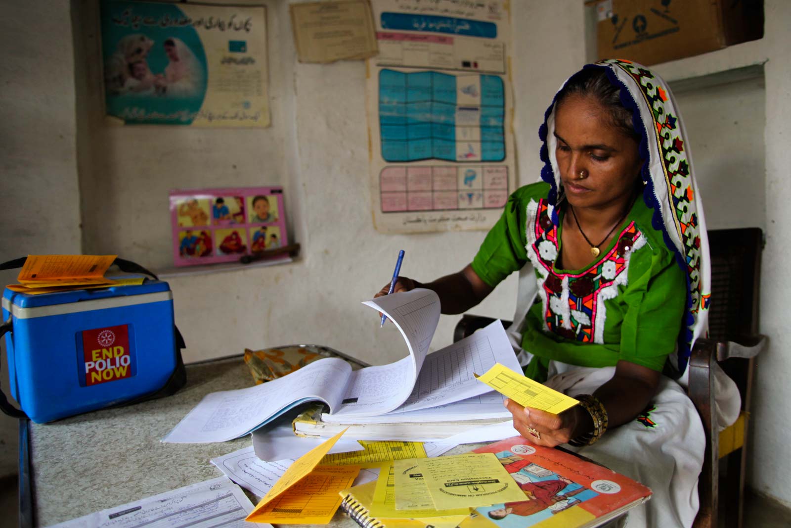  At 8:00 in the morning, Bai plans her workday in the room within her own home that serves as a village health centre, and which she calls the Health House.