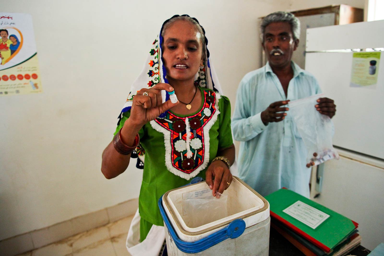  Before starting door-to-door home visits, Bai must make a stop at a district health clinic in Mithi to pick up vaccines. Local families have the option of visiting the clinic for immunisations, but many are unable or unwilling to go there.