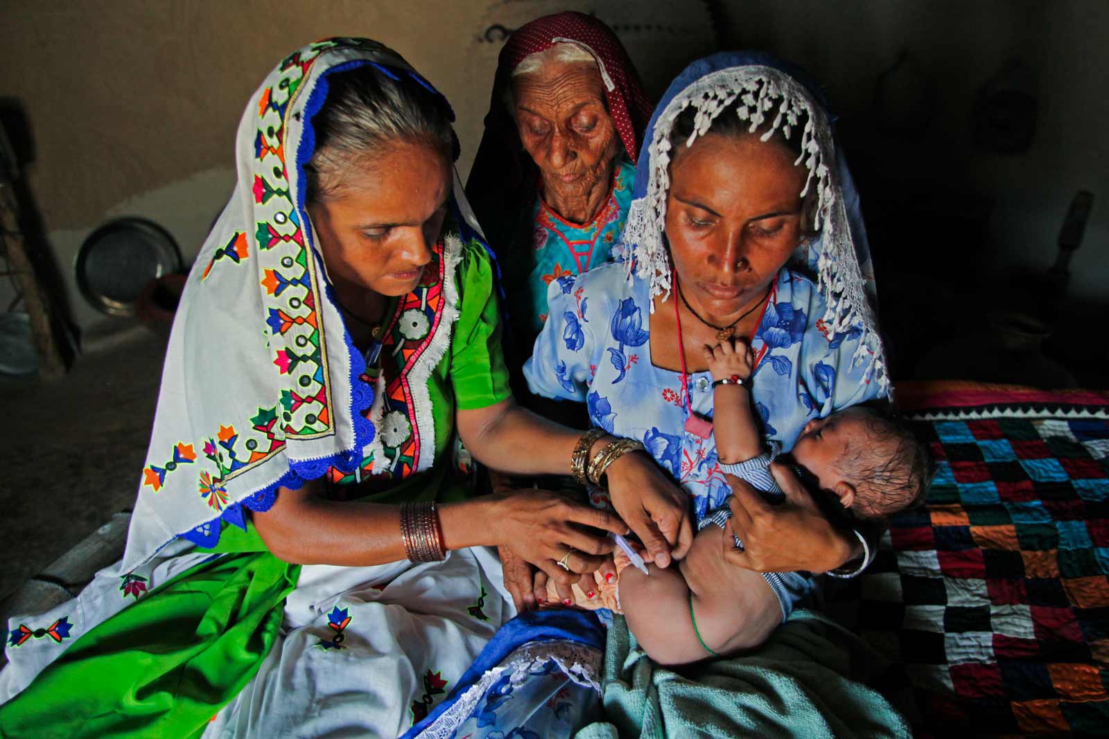  Bai administers pneumococcal vaccine to baby Jetesh, as his mother Seeta Bai, 27, cuddles him. She has also just given the baby polio and pentavalent vaccines.