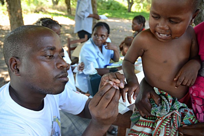 With a high fever, six month-old Abilio Elias Macie cannot receive his second dose of pentavalent. Jose Joaquim Freita Nhavotho performs a rapid malaria test for which Abilio tests positive and is put on a course of anti-malaria medicine.