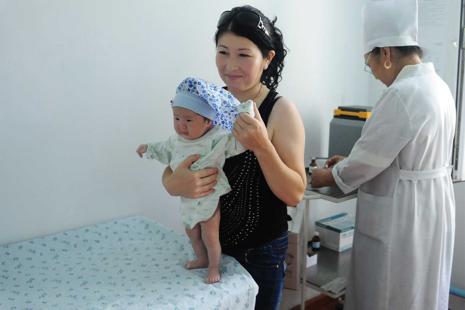  At the Nooken centre, two-month-old Asel’ Sarbayeva gets a welcome distraction in preparation for receiving the five-in-one pentavalent vaccine. The routine use of this vaccine, introduced in 2009 with GAVI support, provides a simpler, less painful way to protect babies against major infectious diseases through a single injection.