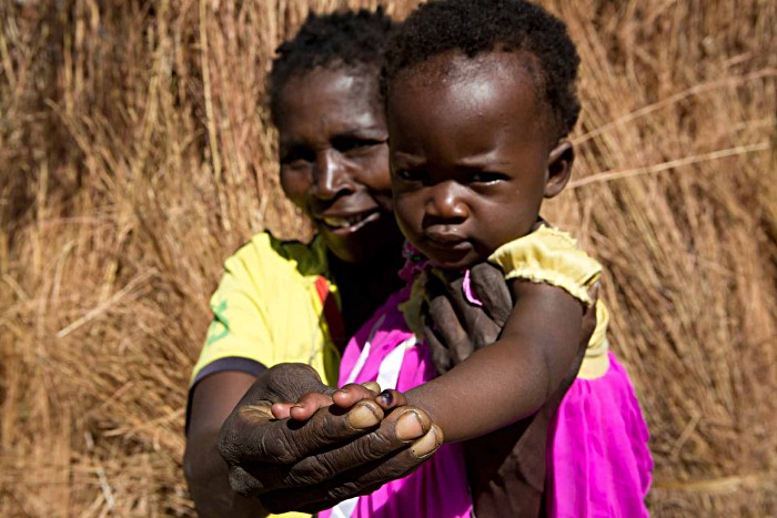 Alabia Alan proudly holds up her daughter’s inky finger – a sign that she has received the measles-rubella vaccine. She is one of close to 8 million children aged between 9 months and 14 years who were immunised as part of a national vaccination campaign in June.