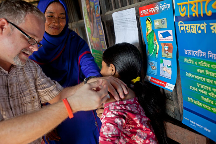 Marvin Meier, World Vision Germany, puts his medical background to use by vaccinating a local mother with pentavalent vaccine – the five in one multivalent that Bangladesh is rolling out with GAVI funding support.
