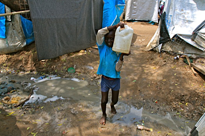 Conditions in the Tomping camp are poor for internally displaced people, and made worse by the current daily rainy season downpours. Drainage channels for run-off rainfall become clogged, and fill with human effluent, but children still need to navigate their way around them. Disease can strike quickly.  