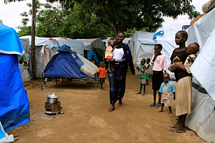 Elizabeth Nyalen, 30, walks through a camp temporarily housing people forced from their homes because of civil conflict in South Sudan. Her husband died in the fighting, and she fled with their five children to seek refuge here at the United Nations base in Juba, the capital.