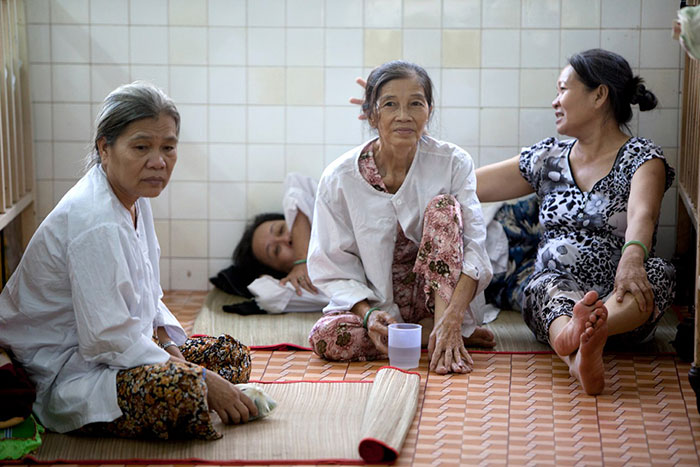 Cervical cancer patients rest on the floor of the women’s cervical cancer ward at the Ho Chi Minh City Oncology Hospital in Vietnam, December 2010.
