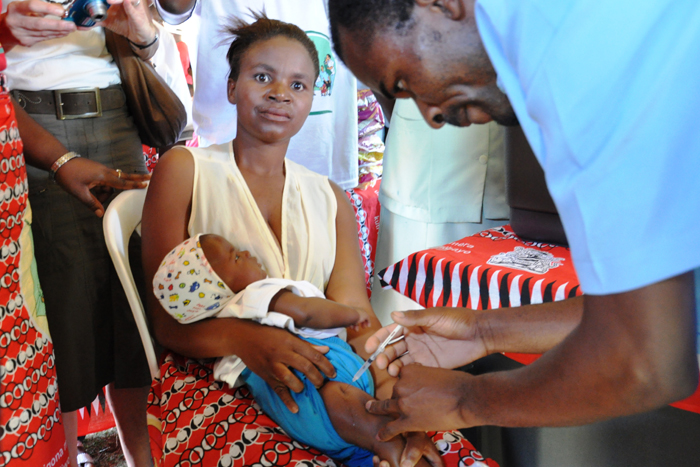 In the arms of his mother Janet, two-month old Bright Masambo Chisale is the first baby in Malawi to be given a pneumococcal vaccine. Vaccinator Clement Saidi was proud to deliver the first vaccine in front the Minister of Health, Dr. Jean Kalilani, and a large crowd of onlookers, which included Malawian and international journalists.