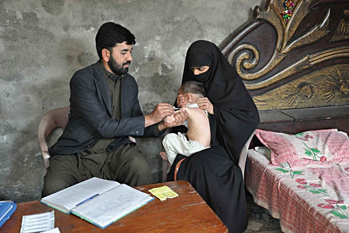 Hasan Abdul Salam flinches as he receives his second dose of measles vaccine in Dhoke Jeelani village near Islamabad. The two-year-old is several months late for the vaccine because his family recently moved, but mother Asma has ensured that all of her three children receive the potentially life-saving vaccine. “Children need to be immunised,” she says, “for us to progress, we need to have healthy children.”