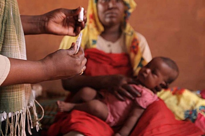 At Baruka village, 40 km outside Khartoum, Howa Hasa Al Rasul watches as a doctor prepares to administer the vaccine that will help protect her daughter Fatima Adil from a disease that causes 40% of all severe diarrhoea cases in Sudan.