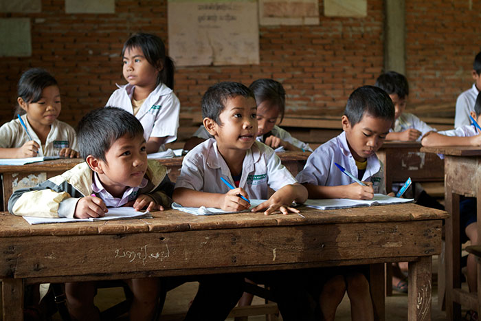 Students study mathematics at Kang village school in southern Laos while health workers set up a vaccination post outside their classroom in November 2011, part of a campaign to protect them from measles and rubella. By preventing death and disease, immunisation gives children the best possible start in life.