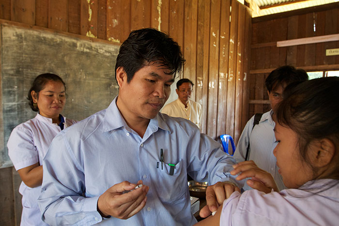 "A recent survey in Laos showed that 35% of girls aged 15-19 had no immunity against rubella", explains Dr. Phounphenjhack Kongxay, Lao's Deputy Manager of the national immunization program. "It was very important to add rubella vaccine to protect women and their newborns." Here Dr Kongxay immunizes a girl in Don Thalat school in the Champasack District of Southern Laos.