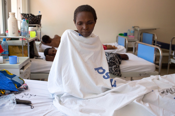 Cervical cancer patient Tabu Kitmonga Kiparu (46) sits upright on her hospital bed – a visible reminder of the real lives behind the statistics.