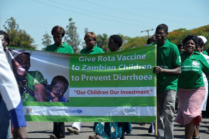 Health workers march proudly to first vaccination ceremony with a banner reinforcing the key public health message that rotavirus vaccines are a critical part of a comprehensive strategy to prevent diarrhoea, a leading killer of young children in Zambia.