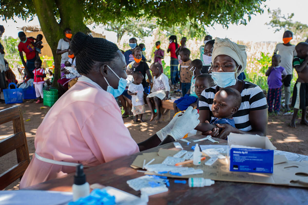 During a medical outreach in Amuru District, Uganda a health worker immunises a young child. Photo: Amref Health Africa