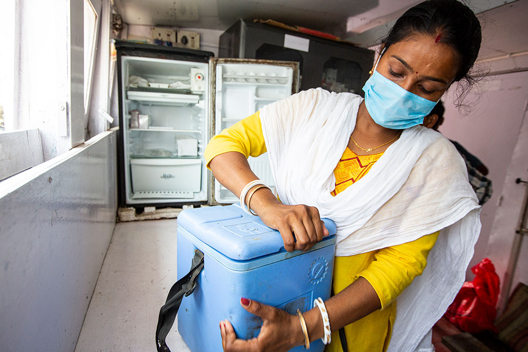 A Nurse on Board the SHIS Hospital Boat is checking the Covishield Vaccine before delivering them to the next Vaccination Point, in the Sunderbarn, India. Gavi/2022/Benedikt v.Loebell