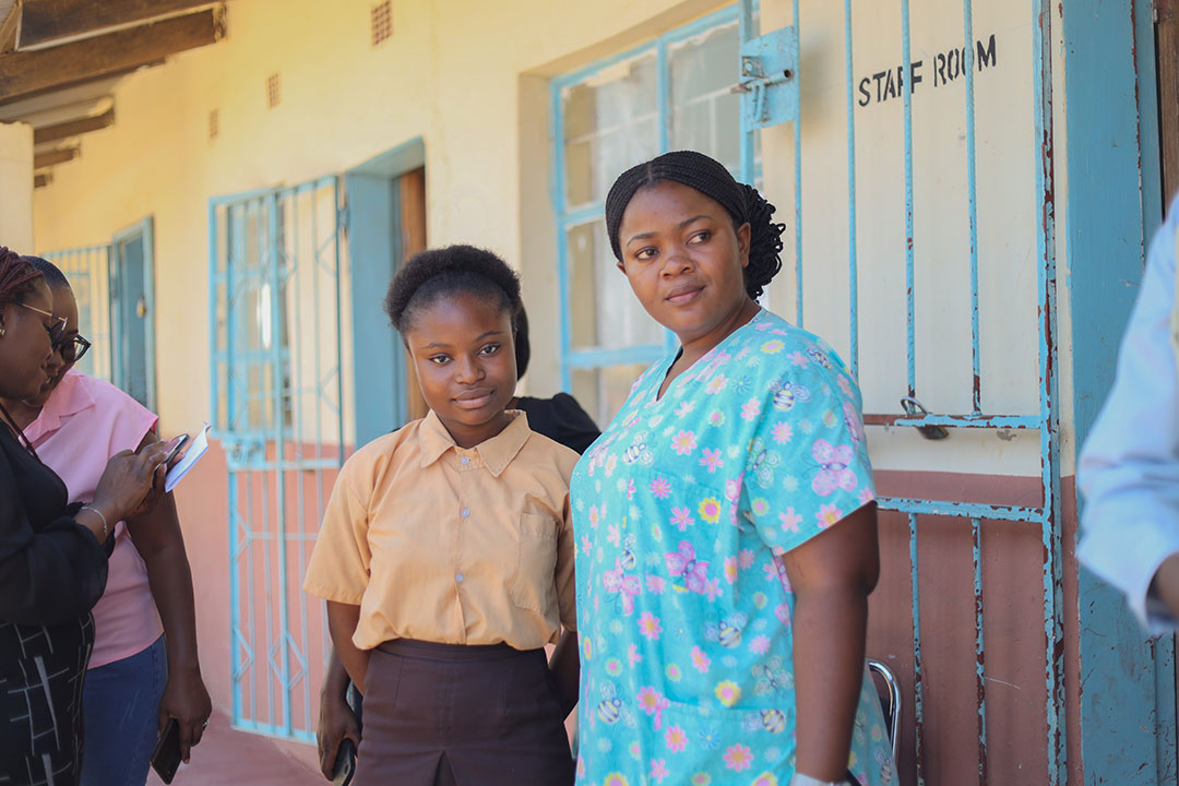 Mirriam Sikaputa, a 26-year-old registered nurse, vaccinating girls at the David Hamushu School in Kabwe. With Miriam, is the young champion, 13-year-old Mirriam Botha smiling after receiving her HPV vaccine. UNICEF/2023/Mapalo Mwenya