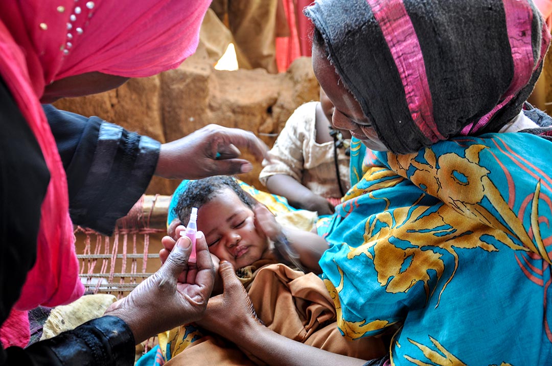 Health worker administering vaccine to baby. Credit: Gavi/Doune Porter
