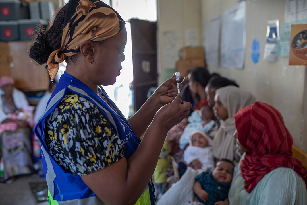 Vaccinations are prepared by a Health Extension Worker while mothers with infants await at the Umer Health Center in Shire Inda Selassie, Tigray Region of Ethiopia. Gavi/2024/Mulugeta Ayene