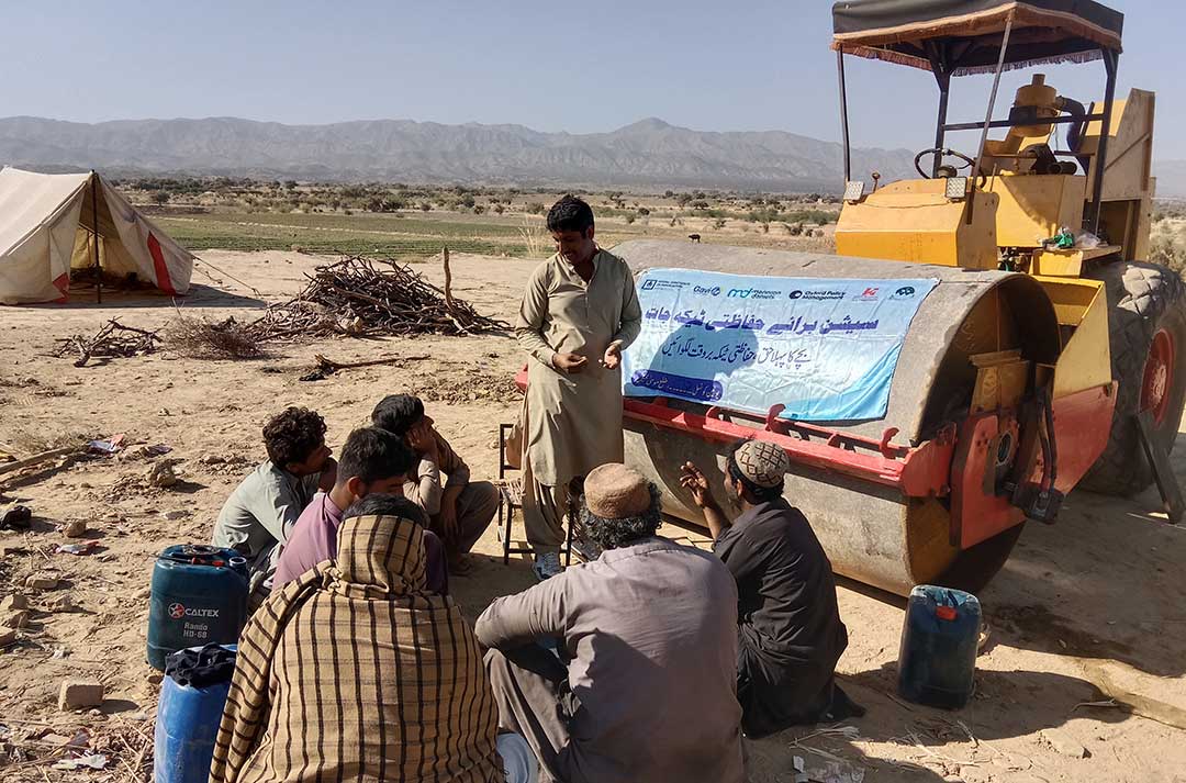 IHHN community mobiliser Ahmed Khan engages local labourers to raise awareness about immunisation in Balochistan, Pakistan. Photo credit: Mujeeb Ur Rehman, District Coordinator IHHN