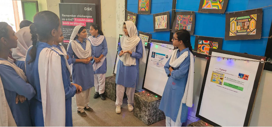 Student presentations at the AMAN World Immunization Week event.