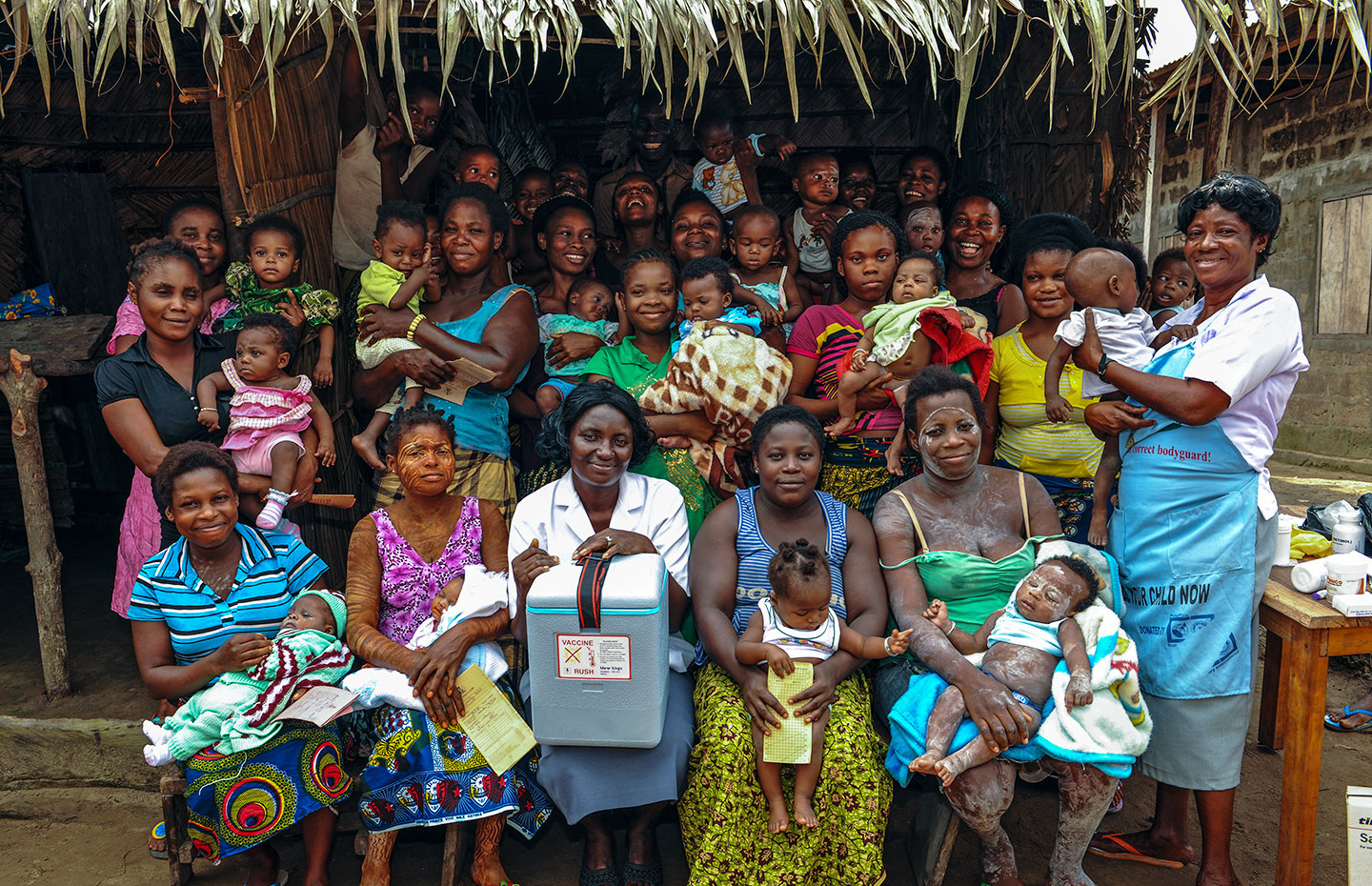 Health workers and locals in Nigeria. Credit: GAVI/2013/Adrian Brooks