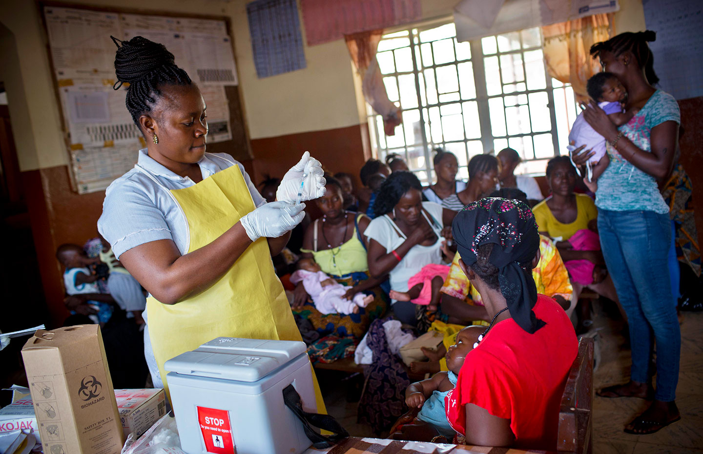 A health worker prepares to vaccinate a baby with a routine vaccination at a health clinic in Freetown. Credit: Gavi/2016/Kate Holt