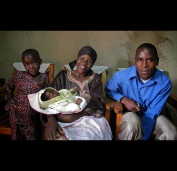 A happy family awaits their child’s receipt of rotavirus vaccine at Rwanda’s launch in 2012. 