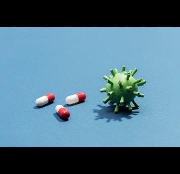 High angle pills beside virus bacteria. Credit: Freepik