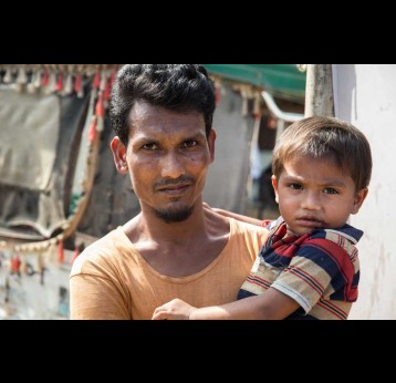 A father and his son at the launch of a cholera vaccination campaign in Bangladesh. Credit: Gavi/2019/Isaac Griberg.