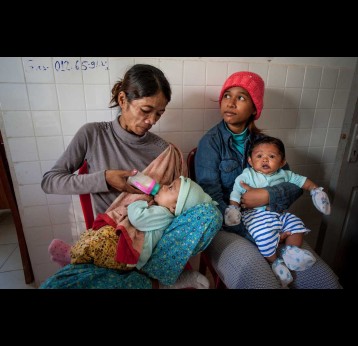 Families waiting to attend a vaccination session at a health centre outside Phnom Penh, Cambodia. Credit: Gavi/2013/Luc Forsyth.