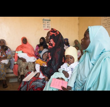 Mothers wait with their children to receive a first dose of diphtheria, tetanus and pertussis-containing vaccine at CSI Madina, a health centre in Niamey, Niger. Gavi/2022/Isaac Griberg