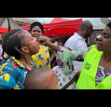 A mother receives a dose of the oral cholera vaccine in North Kivu, Democratic Republic of Congo